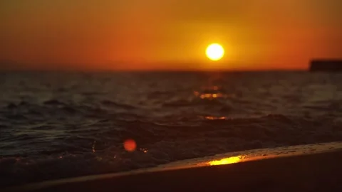 Vertical Cinematic Sunset on Sandy Beach with Vibrant Orange and Blue Sky 스톡 동영상 331899858
