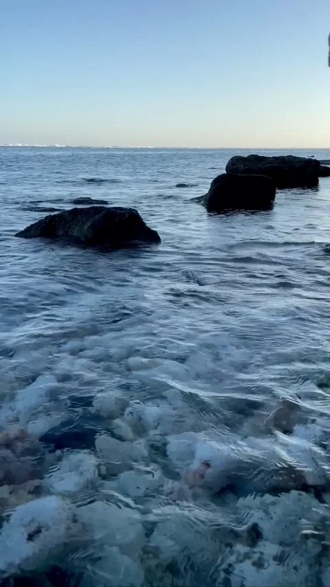 Vertical Clear Ocean Water Over Coastal Rocks in Bali Stock Footage 337336661