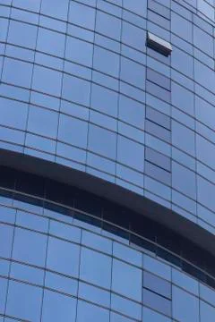 Vertical clear shoot of blue colored glazing facade mass office building Stock Photos