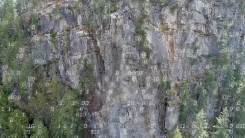 Vertical cliff being scanned as camera closing in, binary overlay appearing at Stock Footage 322204256