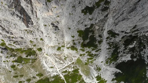 Vertical Cliffs Revealing Tiny Mountain Climbers At Valley Summit In Italian  動画素材 104941965