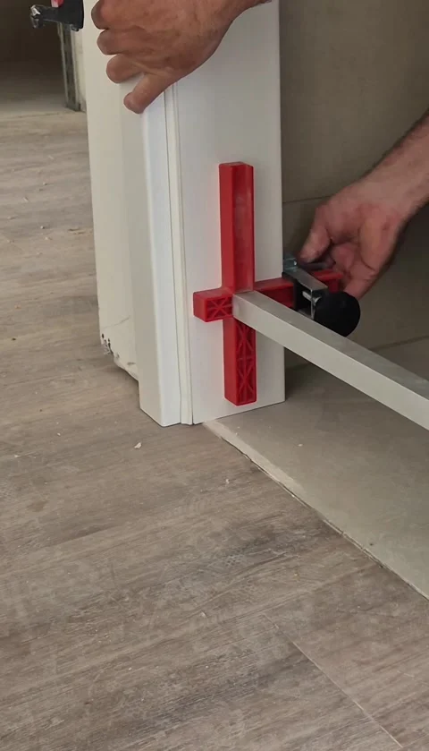 Vertical close up of adjusting door frame brace tool Stock Footage 337847584