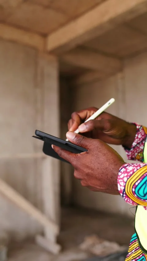 Vertical, Close-up of African Engineer Using Digital Tablet and Stylus on Site Stock Footage 347379663