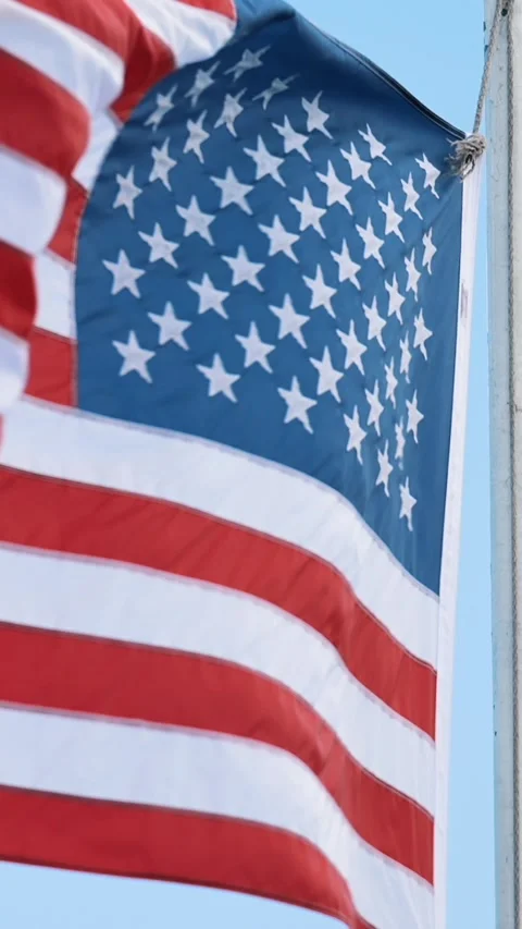 Vertical close up of American flag with visible stars and stripes waving in wind Stock Footage 312586556
