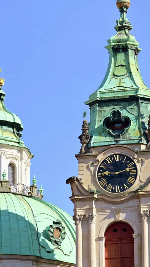 Vertical close-up of the baroque clock tower and green copper dome of St. Stock-Footage 342259147