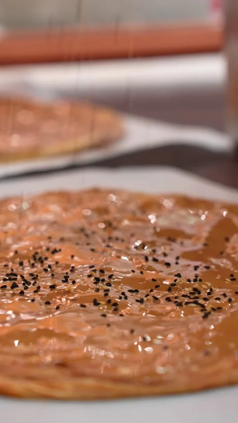 Vertical Close Up of Black Cumin Sprinkled on Tahini Pita Bread Video stock 332415480