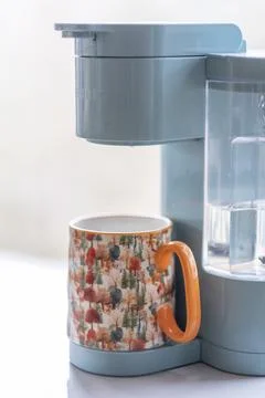 Vertical Close Up of Blue Coffee Machine and Fall Patterned Mug 写真素材