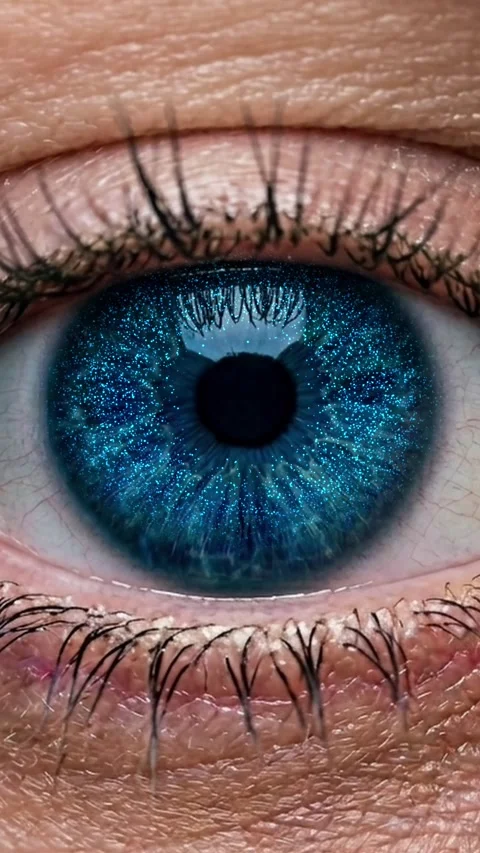 Vertical close up of blue eye with glowing blue starry space overlay Stock Footage 337608729