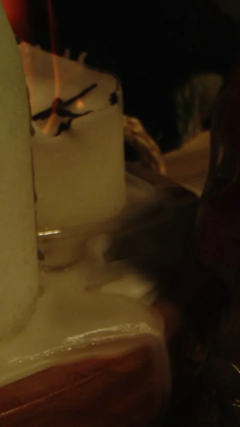 Vertical close of candles, panning towards a blood filled glass skull on the Stock Footage 336367722