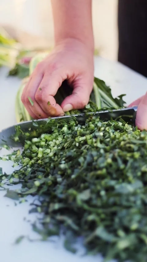 Vertical close up of a chef’s hand chopping a spring lattice Video stock 219470593