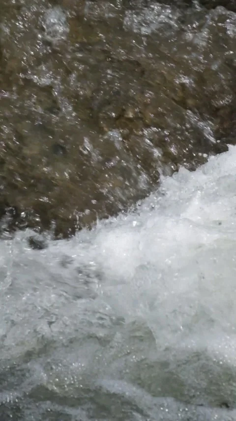 Vertical close up of a clear river splash Video stock 336878392
