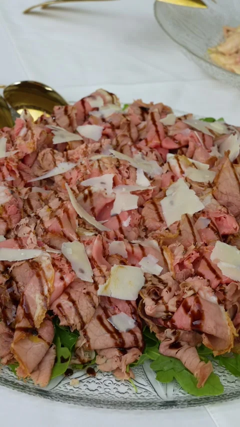 Vertical close-up of cold roast beef platter with Parmesan shavings, balsamic Stock Footage 339196403