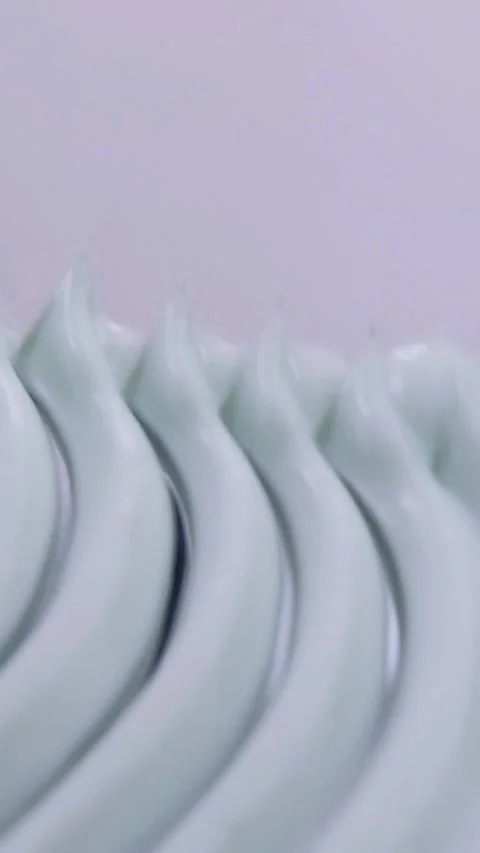 Vertical close up of creating a zigzag pattern on beauty cream using a tool.. Stock Footage 339899272