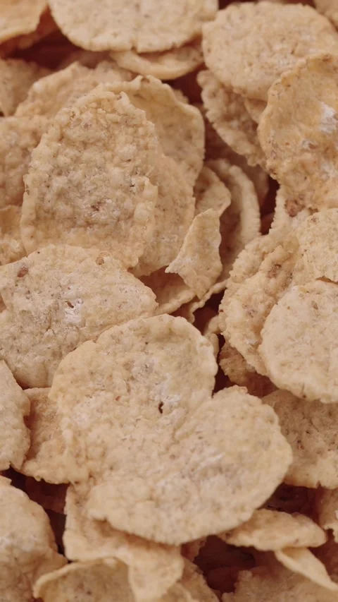 Vertical close-up of crispy gluten-free flakes with milk in a bowl slow motion Stock Footage 318473565