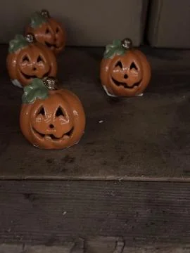 Vertical close up of cute halloween jack o lantern pumpkins figures on wooden Stock Photos