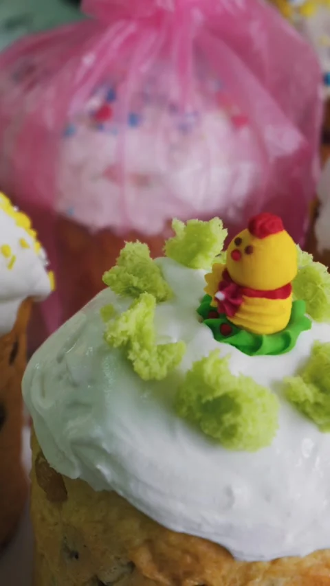 Vertical Close Up of Decorated Easter Kulich Cake with Cute Chick Topper Stock Footage 334124386