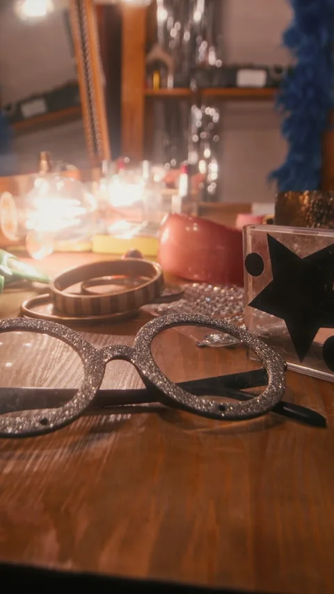 Vertical Close-Up of Disco Star Performance Props Lying on Dressing Table Stock Footage 299671157
