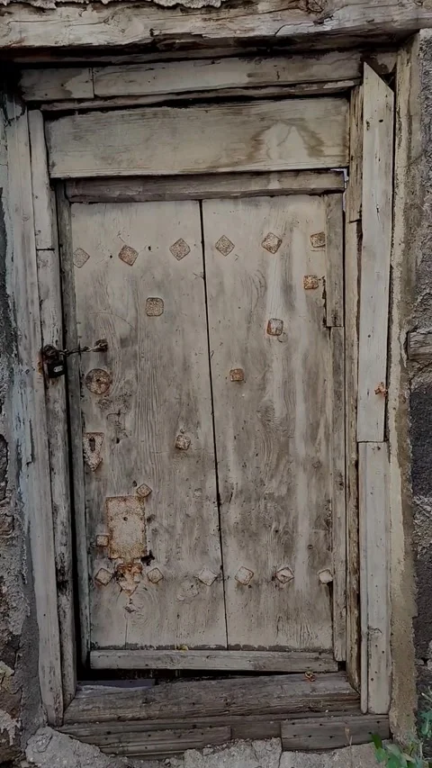 Vertical close-up dolly in shot of a weathered wooden door texture with rust Stock-Footage 328402400