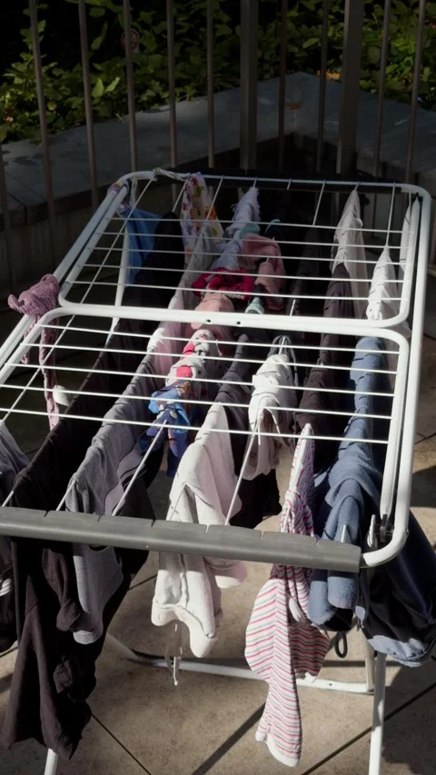 Vertical close up of family laundry drying naturally on a sunny Berlin terrace Stock Footage 346663276