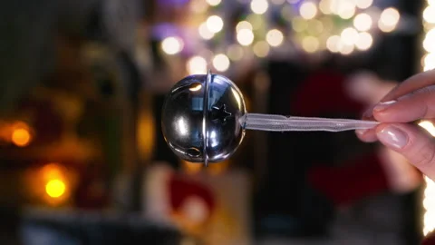 Vertical close up female finger ringing Bell from Santa Claus sleight Christmas Video stock 251999436