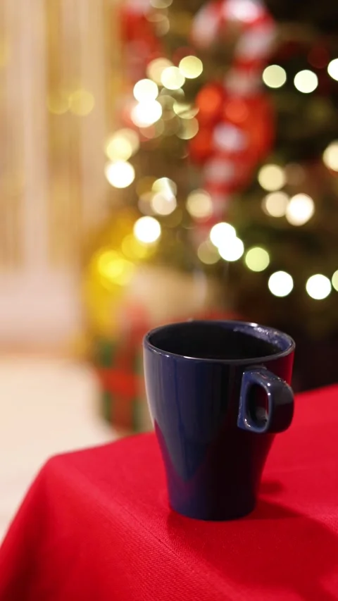 A Vertical Close Up Of A Festive Blue Mug with Steam on Holiday Table Stock Footage 313706334