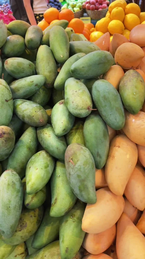 Vertical Close-Up of Fresh Green Mangoes and Dragon Fruit at Tropical street Video stock 340869054