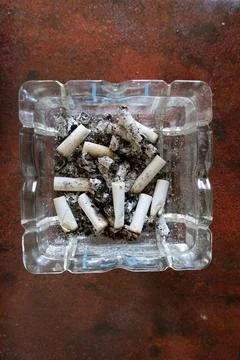 A vertical close-up Full Ashtray with Cigarette Butts Stock-Fotos