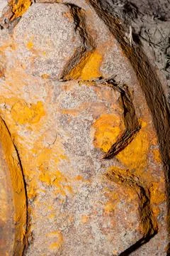 Vertical close-up full frame of dry dirt on a rusty bumpy surface pattern. Stock Photos