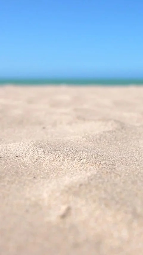 Vertical close-up of grains of sand blowing in the wind on a bright sunny day at 스톡 동영상 292595729