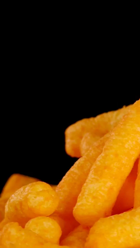 Vertical Close Up of Hand Picking Cheese Puff from Pile Stock Footage 327441410