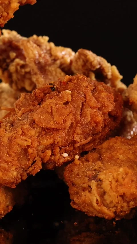 Vertical Close Up of Hand Picking Crispy Fried Chicken Pieces Stock Footage 327272468