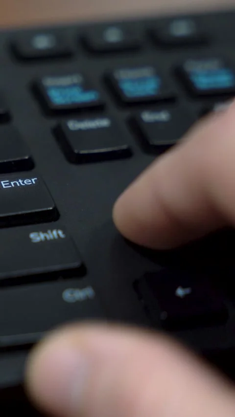 Vertical Close Up of Hand Pressing Enter Key on Computer Keyboard 스톡 동영상 323399340