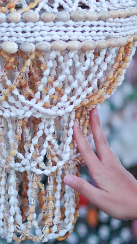 Vertical Close Up of Hand Touching Intricate Seashell Chandelier Decoration Stock Footage 329097327