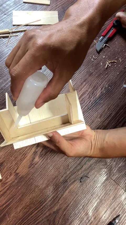 Vertical Close Up Hands Glueing Wooden Board For Miniature House Model. Stock Footage 344839839