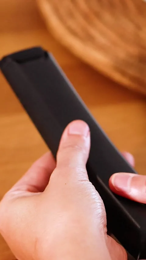 Vertical Close Up of Hands Opening a Television Remote Control Case Stock Footage 329145047