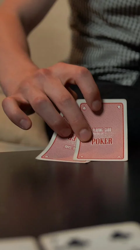 Vertical of Close up of hands with playing cards and chips on table. Stock Footage 278483139