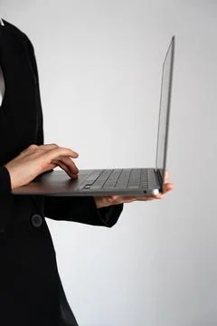 Vertical close-up of hands using laptop on white background Stock Photos