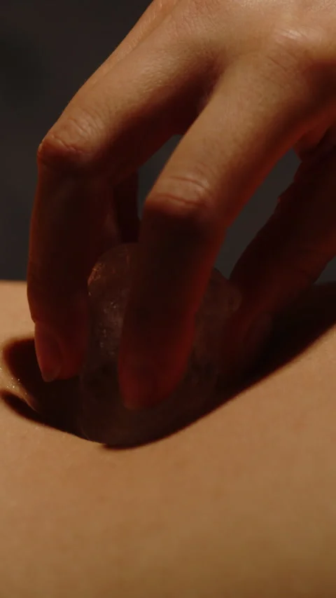 Vertical close up of an ice cube sensually caressing the belly and bellybutton Stock Footage 329212763