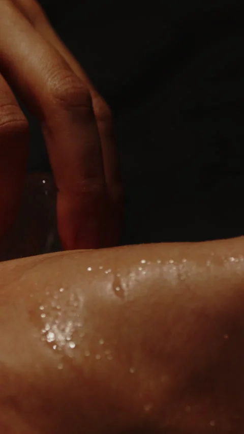 Vertical close up of an ice cube stroking the neck of an attractive woman Stock Footage 329213741