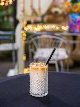 Vertical close-up of an iced latte coffee on a marble table 스톡 사진