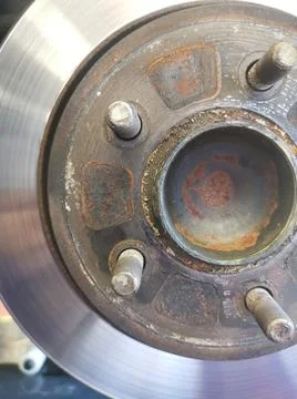 Vertical close up image of slightly rusted worn vehicle brakes Stock Photos