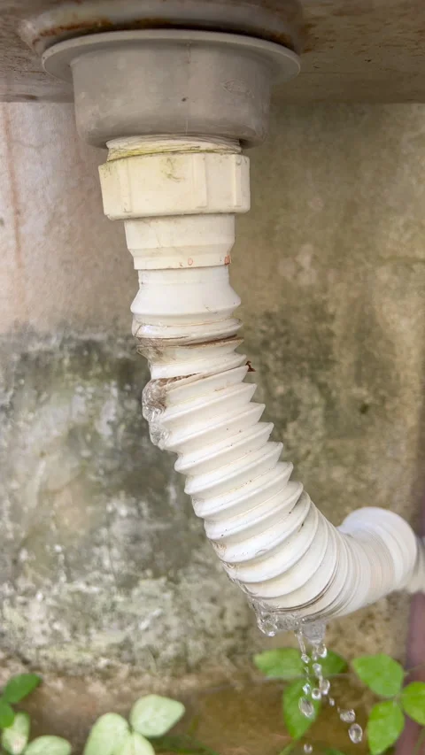 Vertical Close-Up of Leaking Drain Pipe on Concrete Wall Stock Footage 335459071