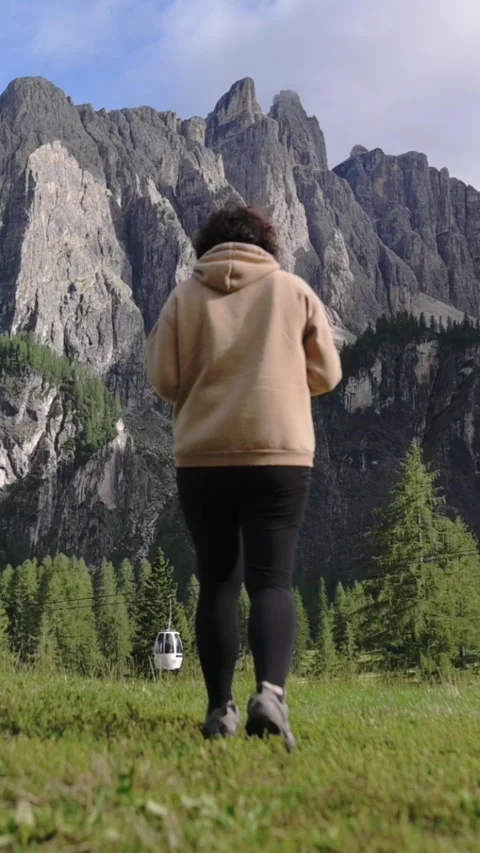 Vertical close-up of legs in motion walking across alpine grass Stock-Footage 318950085