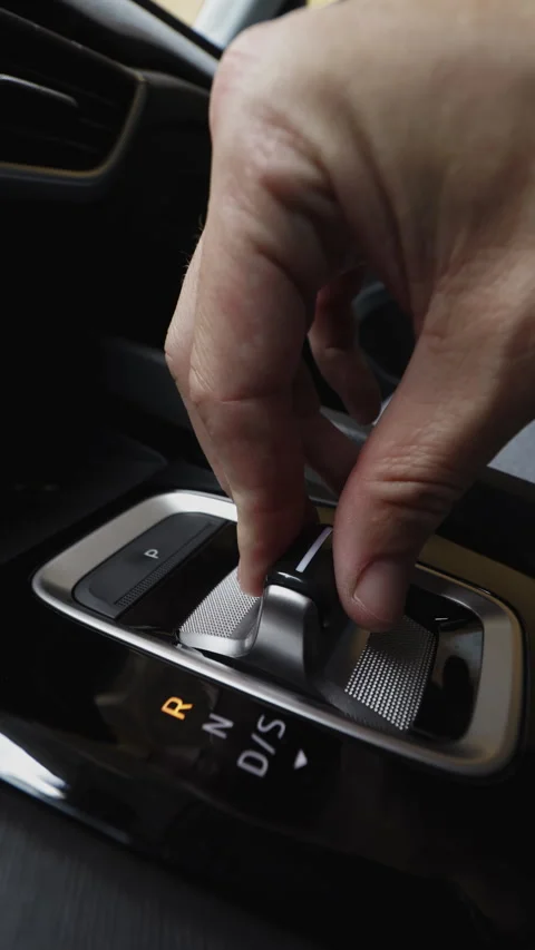 Vertical close up of a male hand shifting gears with a modern automatic tra.. Stock Footage 339078568