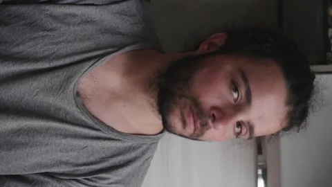 Vertical close-up of man in 30s shaking head at camera Stock Footage 277196702