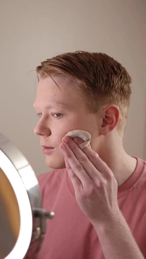 A Vertical Close-Up Of A Man Applying Powder Makeup Mirror Beauty Routine Stock Footage 309902800