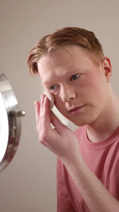 A Vertical Close-Up Of A Man Applying Powder Makeup Mirror Beauty Routine Stock Footage 309904402