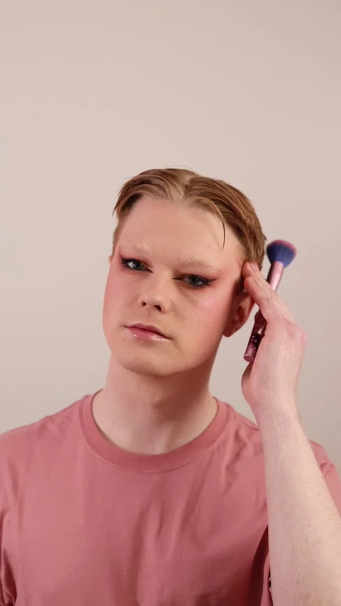 A Vertical Close-up of a Man Holding Makeup Brush Posing with Finished Look Stock Footage 310222510