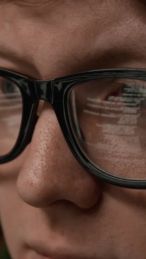 Vertical Close-up of Man Wearing Glasses with Screen Reflection of Code 스톡 동영상 336708650