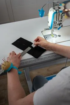 Vertical close up of measuring and marking fabric for tailoring Stock Photos